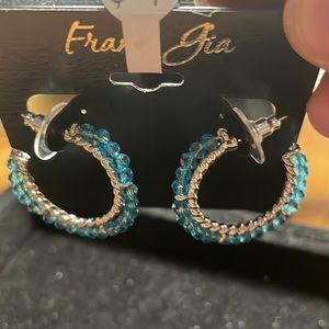 1.2 inches in diameter silver color and blue rhinestone earrings. Fresh color!